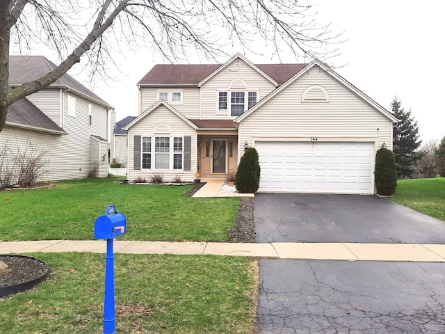 traditional-style home with a garage, a front yard, and aphalt driveway