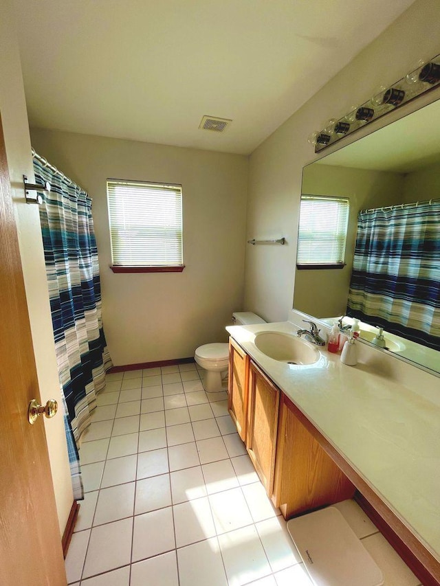 full bathroom featuring visible vents, vanity, curtained shower, toilet, and tile patterned floors