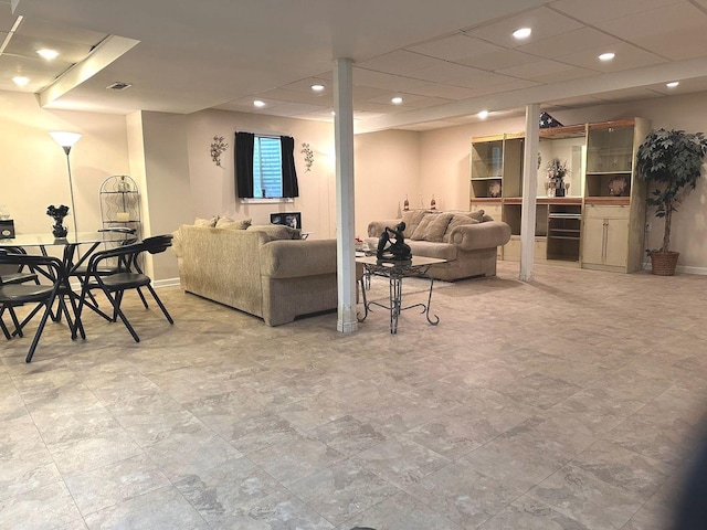 living room featuring baseboards, recessed lighting, and visible vents