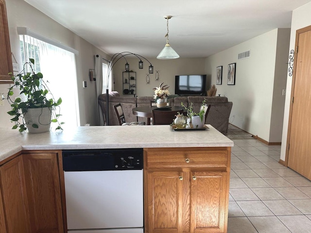 kitchen featuring visible vents, dishwasher, open floor plan, light countertops, and light tile patterned floors