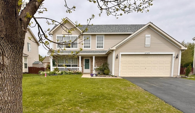 view of front of property featuring a front lawn, aphalt driveway, roof with shingles, and covered porch