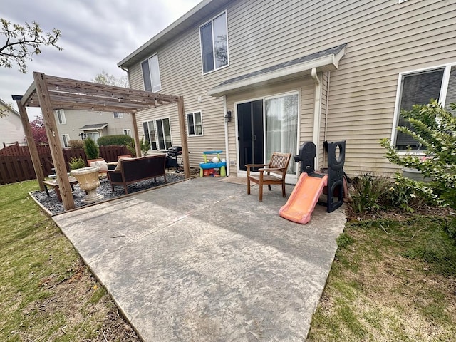 rear view of property featuring fence, a pergola, an outdoor hangout area, a patio, and a yard