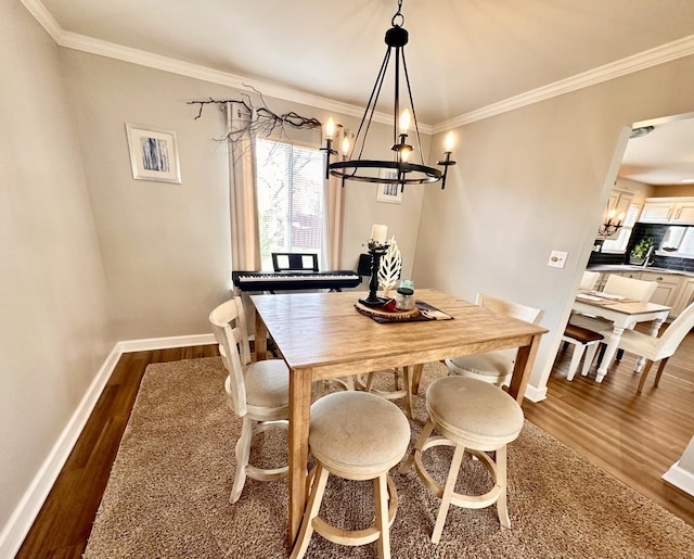 dining space with crown molding, baseboards, an inviting chandelier, and dark wood-style floors