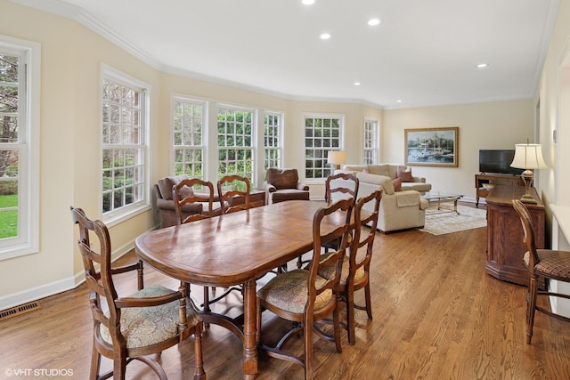 dining area with crown molding, recessed lighting, baseboards, wood finished floors, and visible vents
