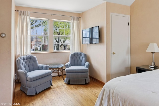 bedroom with baseboards and hardwood / wood-style floors