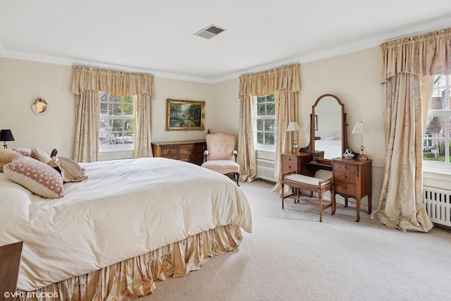 carpeted bedroom featuring crown molding, radiator heating unit, and visible vents