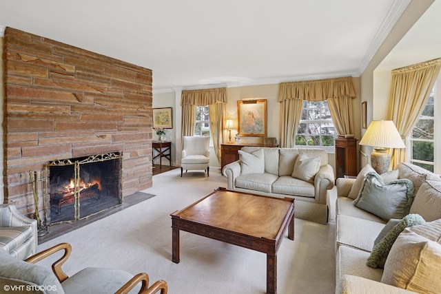 living area featuring carpet floors, ornamental molding, and a fireplace