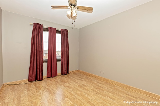 empty room featuring ceiling fan, baseboards, and light wood-type flooring