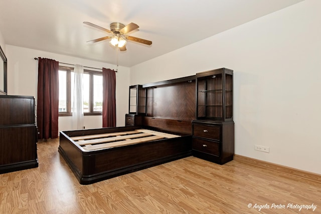 bedroom with ceiling fan and light wood-style flooring