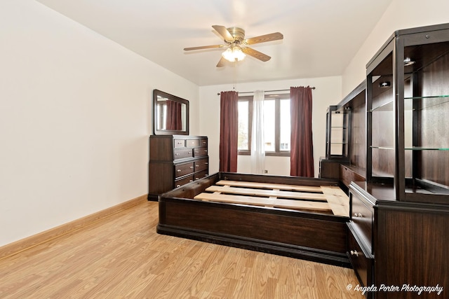 bedroom with baseboards and light wood-type flooring