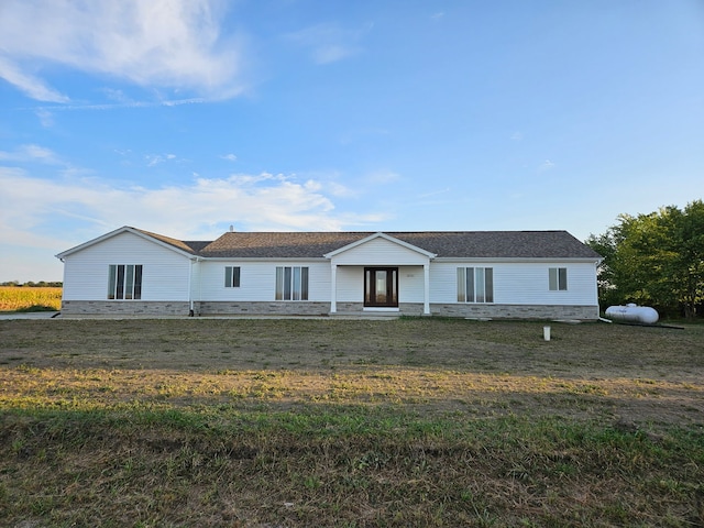 view of front of property featuring a front yard and stone siding