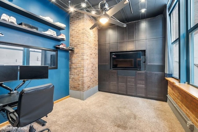carpeted office featuring baseboards, brick wall, and a high ceiling