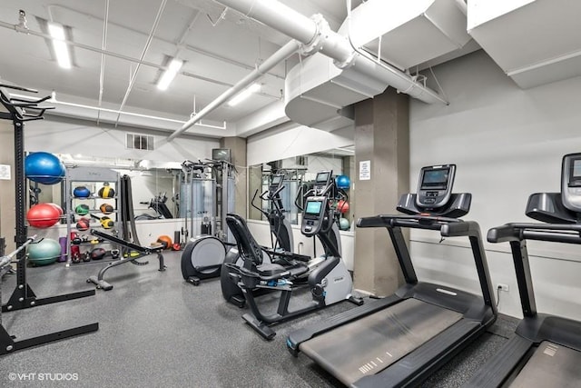 workout area with a garage and visible vents