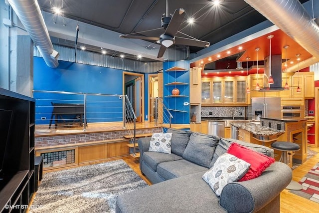 living room featuring ceiling fan and light wood-style flooring