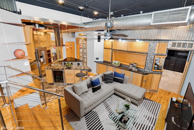 interior space with visible vents, light wood-style flooring, and wine cooler