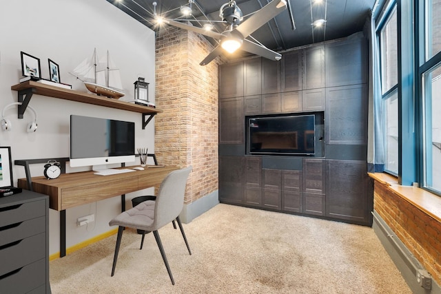 office featuring a high ceiling, carpet flooring, and brick wall