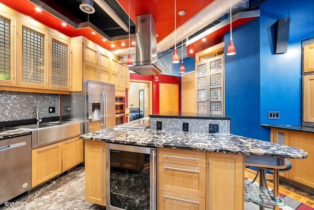 kitchen with beverage cooler, decorative backsplash, appliances with stainless steel finishes, and a center island
