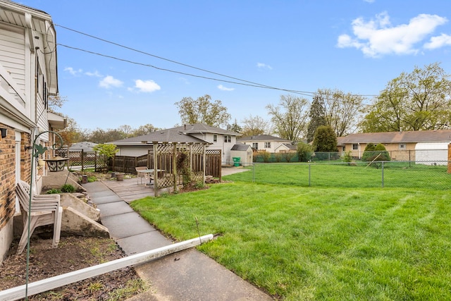 view of yard featuring a fenced backyard, an outbuilding, and a shed