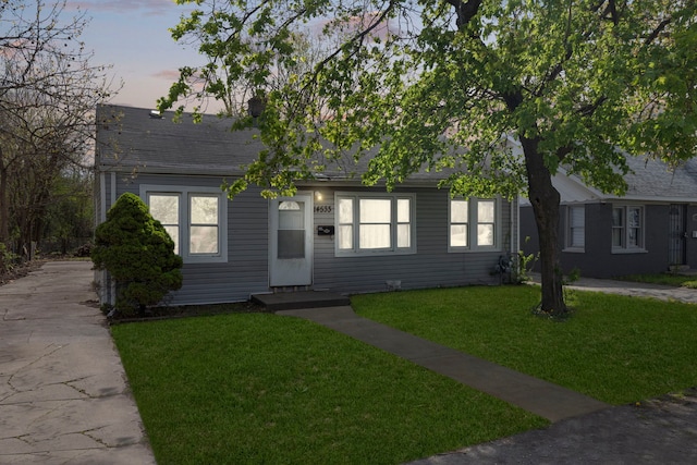 14533 Ashland Ave, Harvey, IL 60426 - view of front of home with roof with shingles, driveway, and a front yard