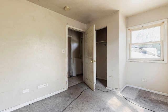 14533 Ashland Ave, Harvey, IL 60426 - unfurnished bedroom with light colored carpet, baseboards, and a closet