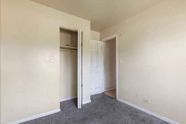 14533 Ashland Ave, Harvey, IL 60426 - unfurnished bedroom featuring baseboards, carpet, and a closet