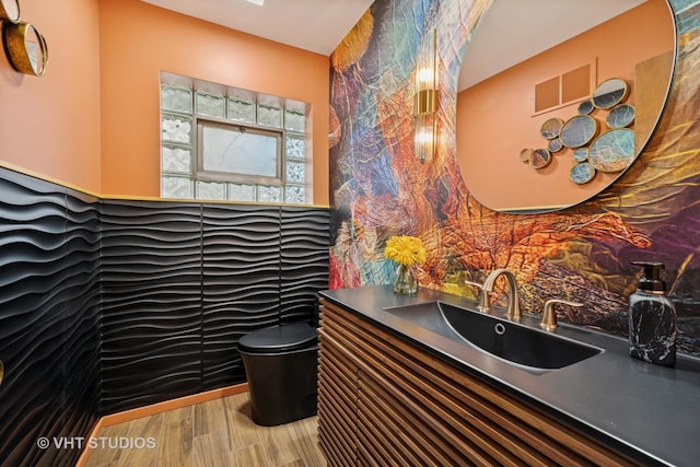 half bathroom featuring toilet, visible vents, and vanity