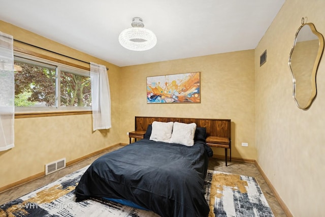 bedroom featuring baseboards and visible vents