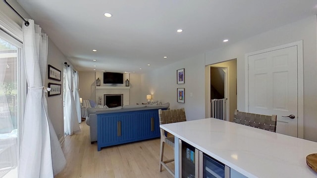 1938 Keim Dr, Wheaton, IL 60189 - kitchen featuring blue cabinets, a fireplace, light wood-type flooring, recessed lighting, and open floor plan