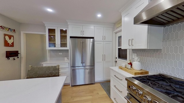 1938 Keim Dr, Wheaton, IL 60189 - kitchen with stainless steel appliances, wall chimney exhaust hood, light countertops, decorative backsplash, and recessed lighting