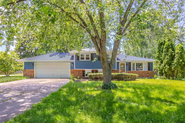 28W521 Donald Ave, West Chicago, IL 60185 - split level home featuring brick siding, an attached garage, concrete driveway, and a front yard