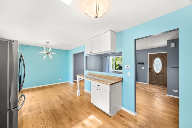 28W521 Donald Ave, West Chicago, IL 60185 - kitchen featuring stainless steel refrigerator with ice dispenser, white cabinets, a chandelier, light wood finished floors, and light countertops
