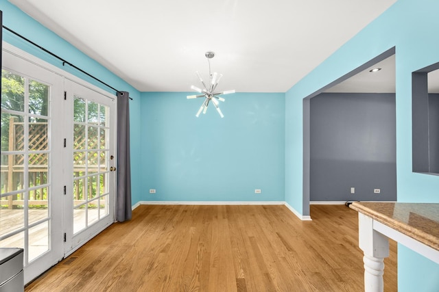 28W521 Donald Ave, West Chicago, IL 60185 - unfurnished dining area featuring a chandelier and light wood-style flooring
