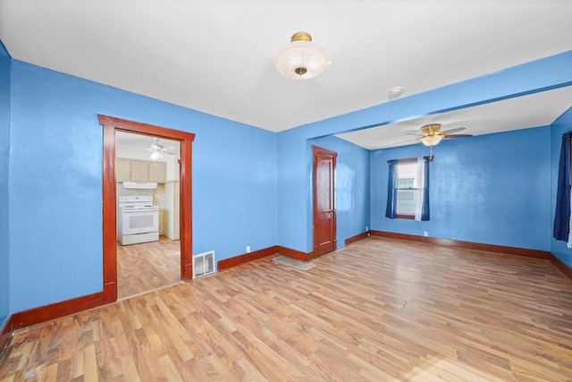 unfurnished room featuring visible vents, a ceiling fan, light wood-style flooring, and baseboards
