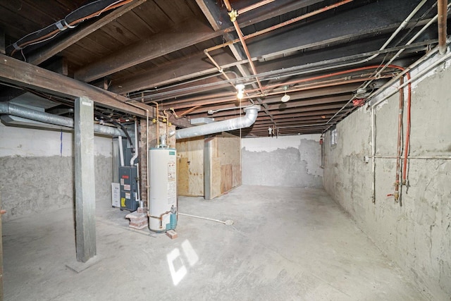 unfinished basement featuring gas water heater and heating unit