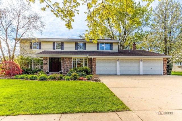 traditional-style house with driveway, a front yard, brick siding, an attached garage, and a chimney