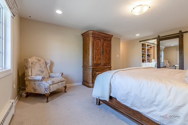 bedroom featuring a barn door, baseboard heating, light carpet, recessed lighting, and baseboards