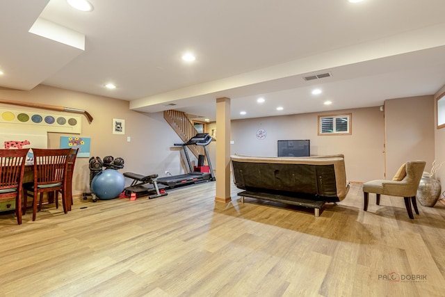 exercise room featuring wood finished floors and recessed lighting