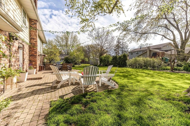 view of green lawn featuring a patio area