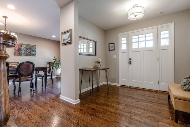 foyer entrance with wood finished floors, baseboards, a chandelier, and recessed lighting