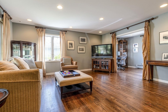 living room featuring a baseboard heating unit, wood finished floors, baseboards, and recessed lighting