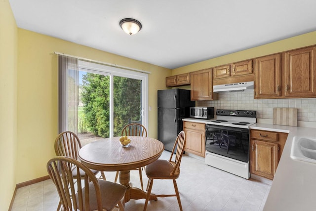3038 Ashton Ct, Westchester, IL 60154 - kitchen with light countertops, electric stove, freestanding refrigerator, stainless steel microwave, and under cabinet range hood