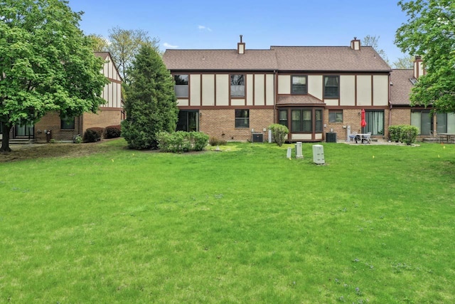 3038 Ashton Ct, Westchester, IL 60154 - back of property with a yard, central AC, and brick siding