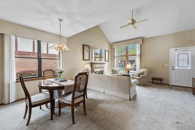 3038 Ashton Ct, Westchester, IL 60154 - dining room featuring a glass covered fireplace, baseboards, high vaulted ceiling, light colored carpet, and ceiling fan with notable chandelier