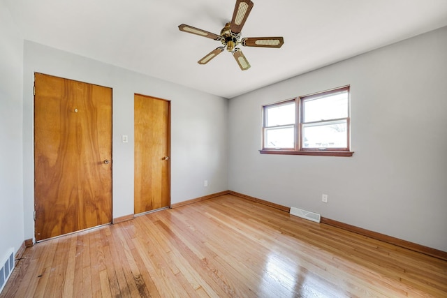 525 Mackinaw Ave, Calumet City, IL 60409 - unfurnished bedroom featuring visible vents, light wood-style flooring, ceiling fan, and baseboards
