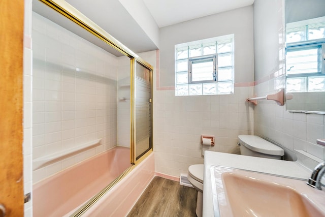 525 Mackinaw Ave, Calumet City, IL 60409 - full bath with visible vents, tile walls, wood finished floors, a sink, and toilet