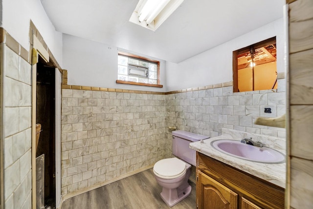 525 Mackinaw Ave, Calumet City, IL 60409 - bathroom with wainscoting, vanity, toilet, tile walls, and wood finished floors
