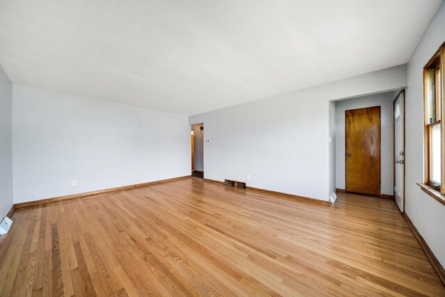 525 Mackinaw Ave, Calumet City, IL 60409 - unfurnished living room featuring baseboards, light wood finished floors, and visible vents