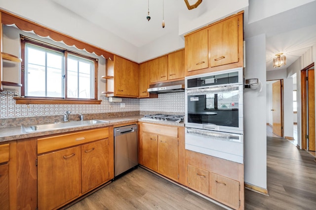 525 Mackinaw Ave, Calumet City, IL 60409 - kitchen featuring appliances with stainless steel finishes, a sink, light wood-style floors, under cabinet range hood, and a warming drawer