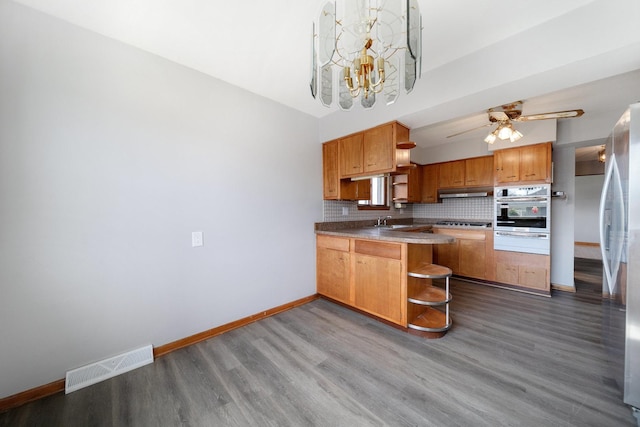 525 Mackinaw Ave, Calumet City, IL 60409 - kitchen featuring visible vents, open shelves, a peninsula, baseboards, and stainless steel appliances