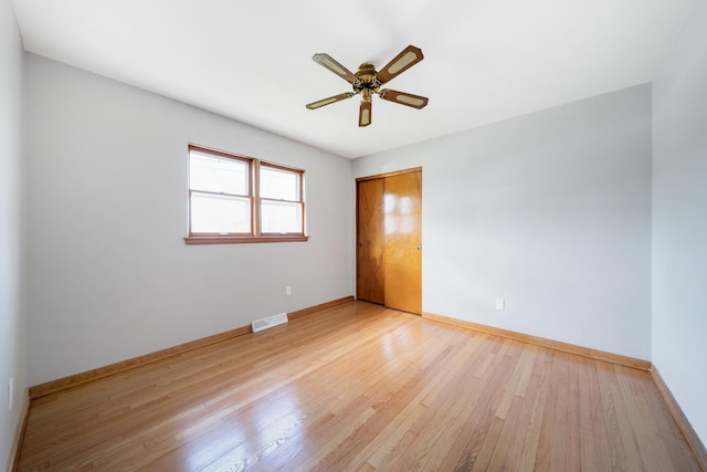 525 Mackinaw Ave, Calumet City, IL 60409 - spare room with visible vents, light wood-style flooring, ceiling fan, and baseboards